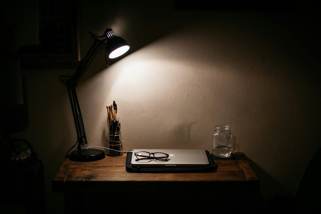 Adjustable desk lamp providing focused task lighting on a work desk